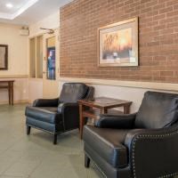 a living room with leather chairs and a brick wall